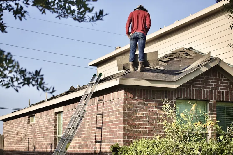 Professional roofer working on a residential roof in Stonegate